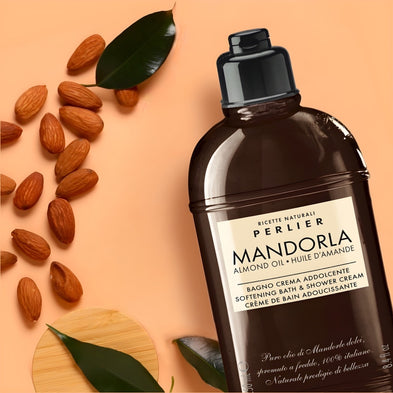 Perlier Mandorla almond oil body wash with almonds and leaves on a peach background