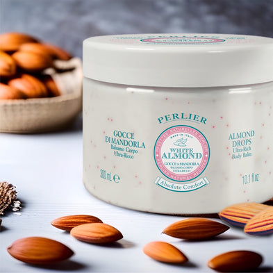 Perlier White Almond body balm with almonds on a table