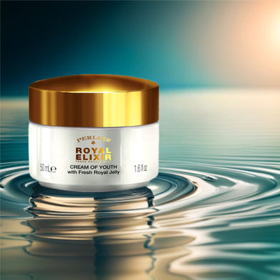 Perlier Royal Elixir Cream of Youth jar with gold lid on water