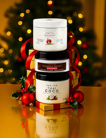 Three jars of Perlier body creams stacked on a reflective surface with a festive background