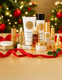Perlier Royal Elixir skincare products with Christmas decorations on a gold surface