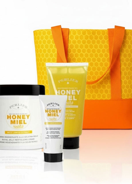 3 Perlier Honey Lemon body care products with a honeycomb-patterned bag on a white background