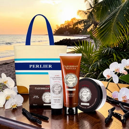 4 Perlier Caribbean Vanilla body care products in front of a striped tote bag in a tropical beach setting