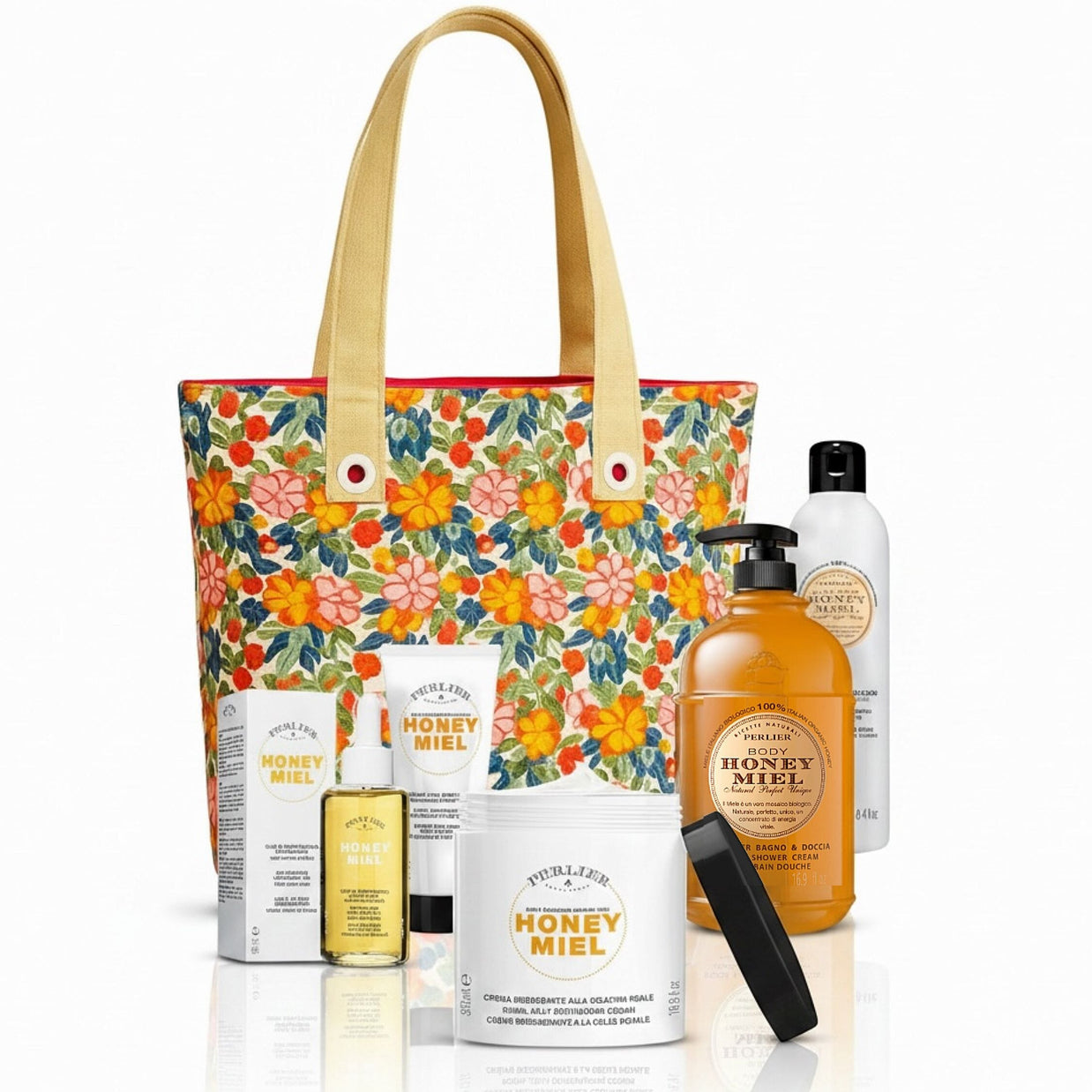 5 Perlier Honey Miel body care products and a floral tote bag on a white background