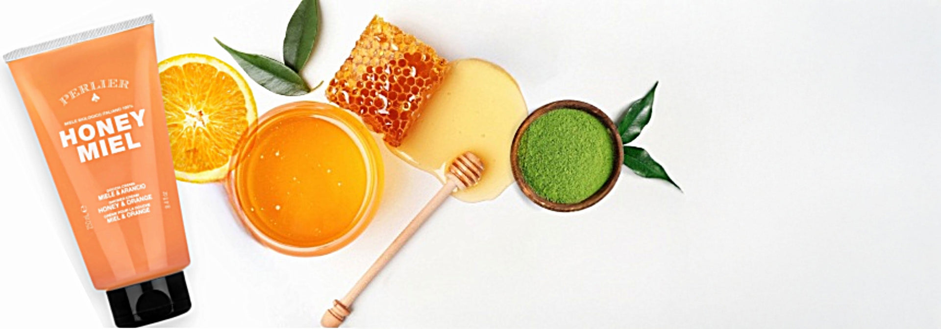 Perlier Honey & Orange Shower Gel on white background next to honeycomb and other natural ingredients