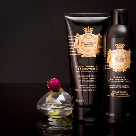 Impeial Honey shampoo and conditioner on a dark background