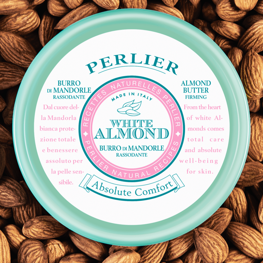 PERLIER 13.5 OZ WHITE ALMOND FIRMING BODY BUTTER OVERHEADVIEW SURROUNDED BY ALMONDS